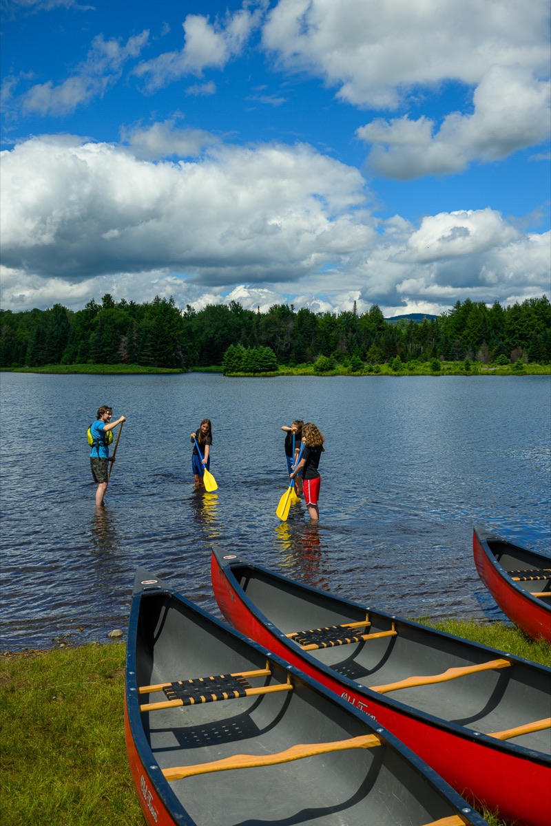 counselor teaching a paddle stroke